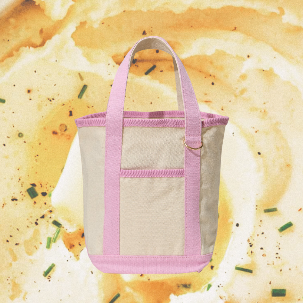Tote bag with pink straps on a background of mashed potatoes.